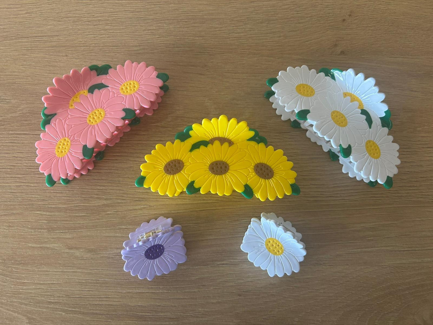 All Daisy Bunch Hair Claws Together Laying Angled Organized Next to One Another - Front View