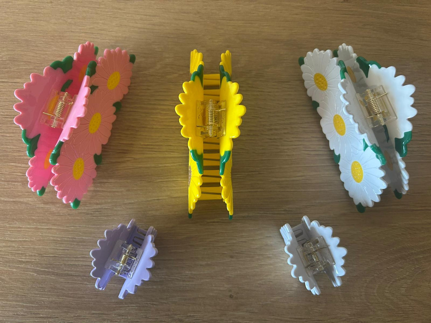 All Daisy Bunch Hair Claws Together Laying Angled Organized Next to One Another - Top View