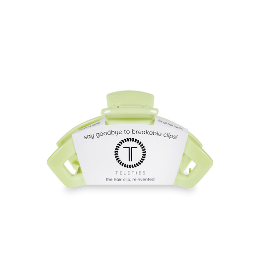 Green hair clip with Teleties branding on a white background